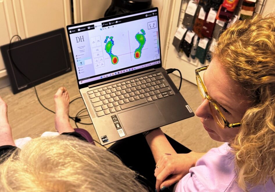 Sarah Bradley of One Step Ahead Podiatry in Whitefield reviewing a patient's gait analysis