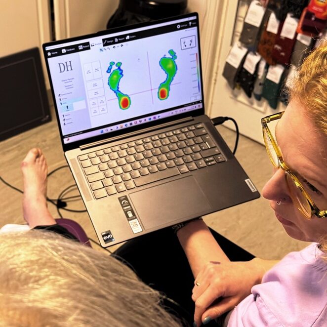 Sarah Bradley of One Step Ahead Podiatry in Whitefield reviewing a patient's gait analysis